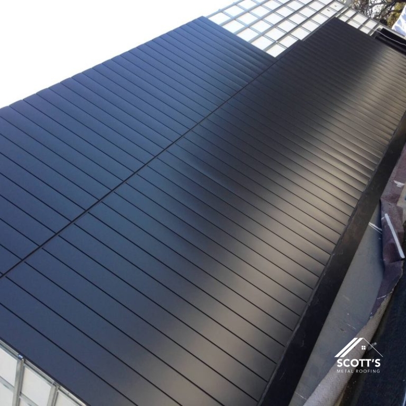 Sleek black Industrial Metal Roofing with a modern standing seam design, offering superior weather resistance and aesthetic appeal.