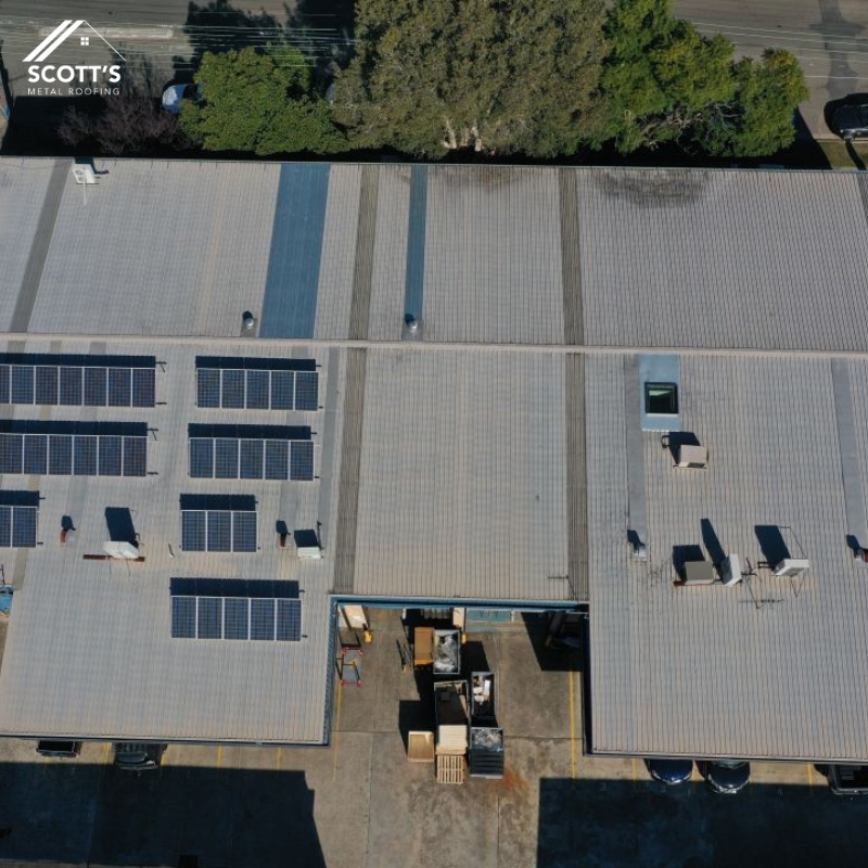 Commercial metal roofing with solar panels on an industrial building, installed by Scott's Metal Roofing in NSW, Australia.