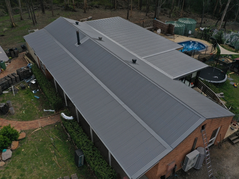 Modern grey metal roof on a house, checking for potential metal roof leaks.