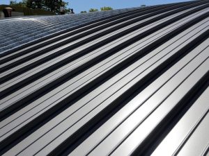 Shiny new corrugated metal roof showcasing the benefits of metal roofing for durability and sleek aesthetics.