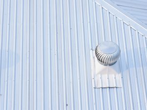 Maintaining a metal roof with a rooftop turbine vent for proper ventilation